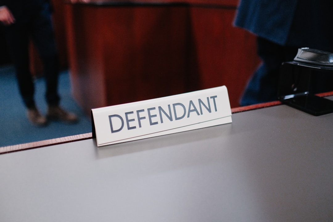 insurance liability. A desk with a sign on it that says defend