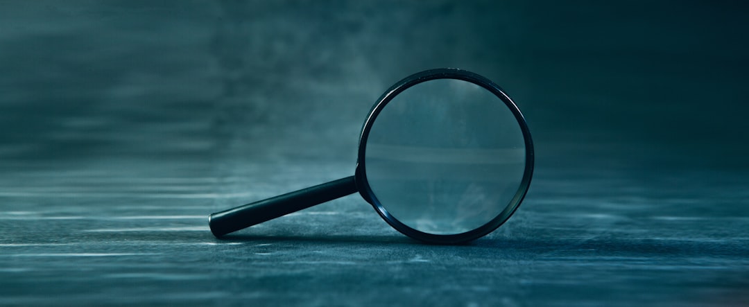support animal fraud — A magnifying glass rests on a textured surface.