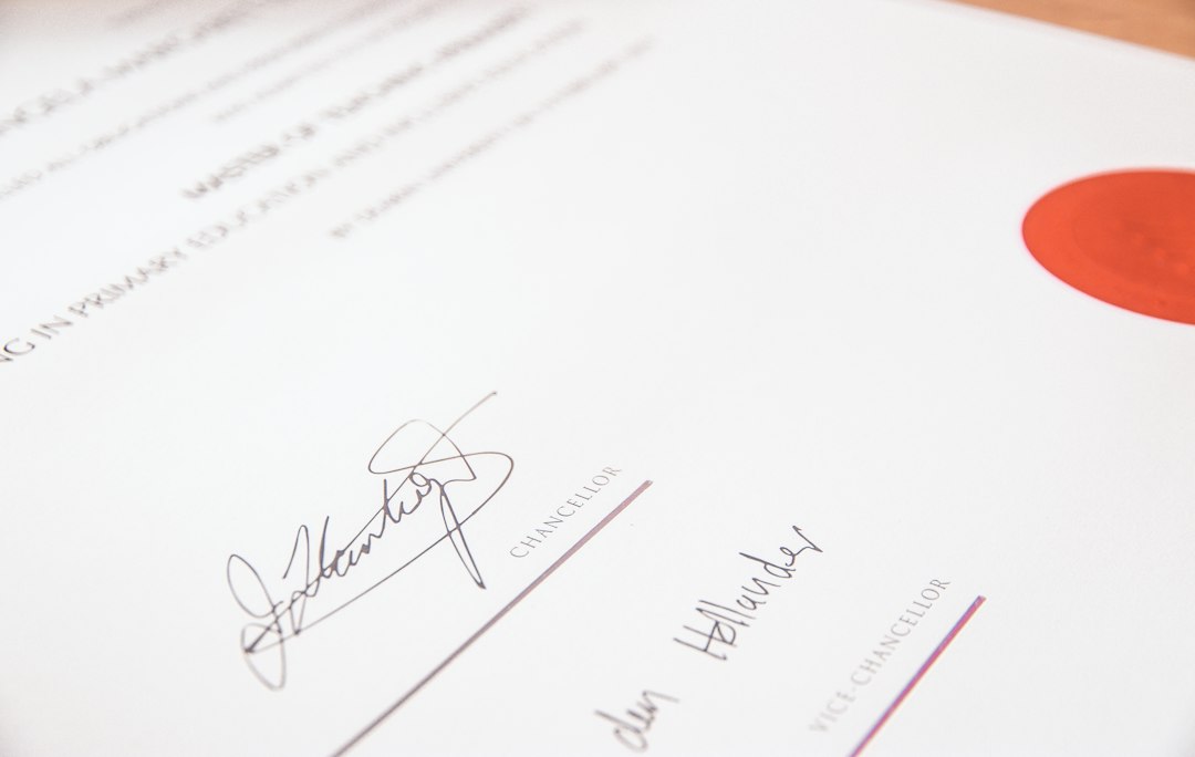 fraudulent support animal letters — A university degree certificate with a red seal and two signatures