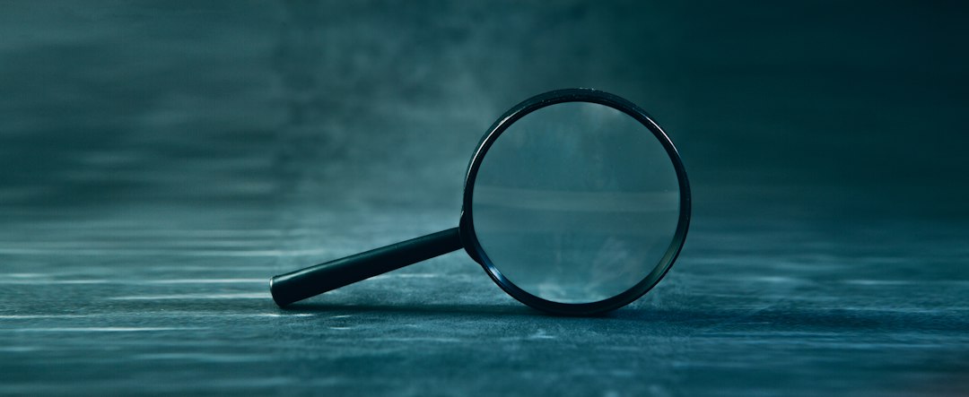 QR code verification — A magnifying glass rests on a textured surface