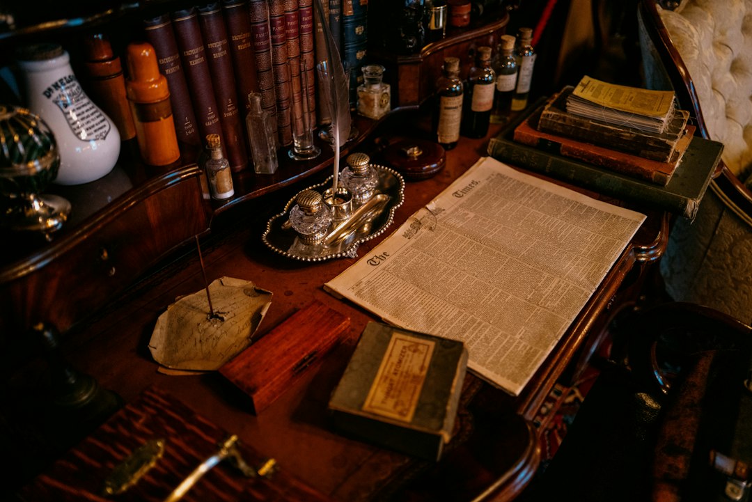 support animal liability insurance — Old desk with books, inkwell, and papers